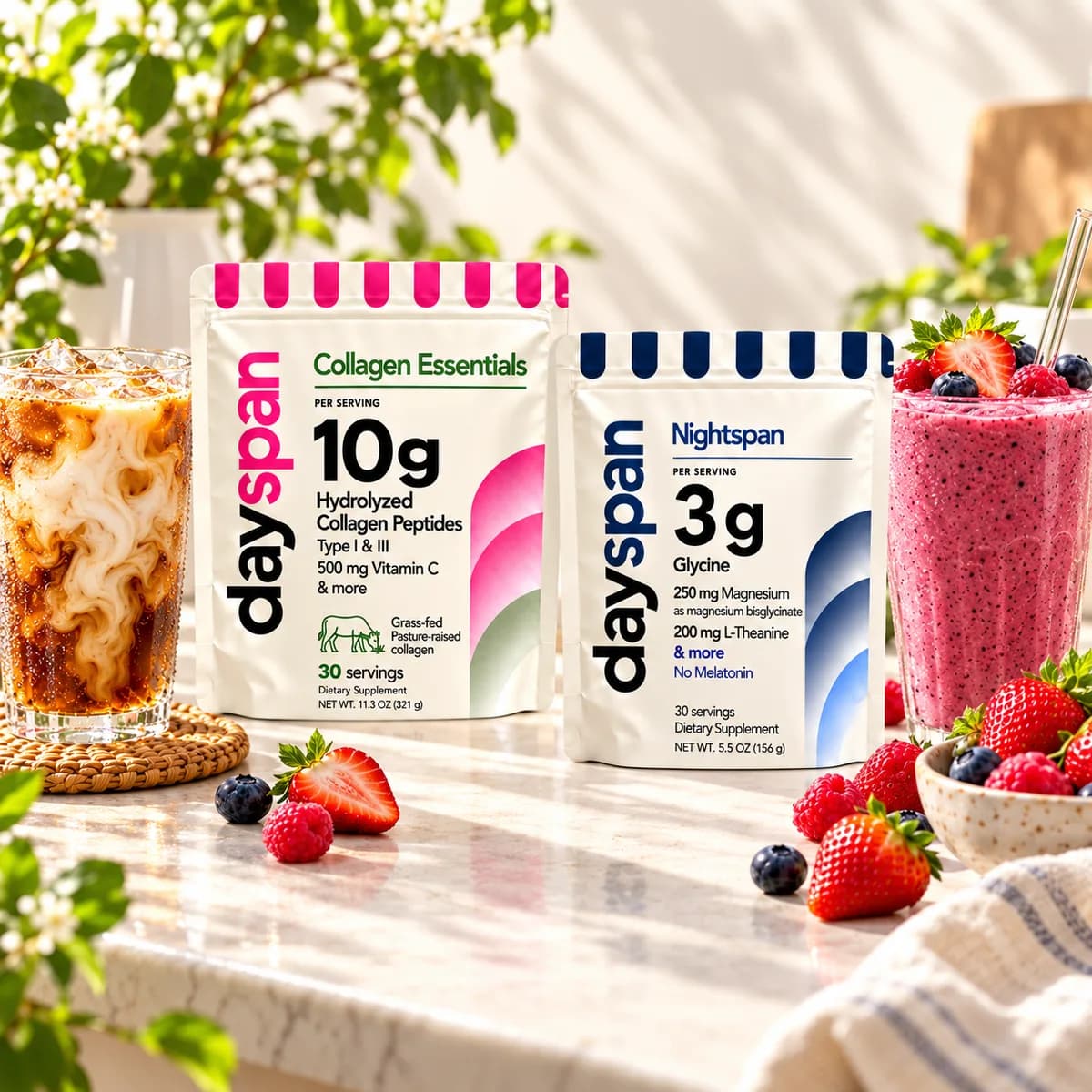 Dayspan Collagen Essentials and Nightspan with an iced latte, berry smoothie and fresh berries on a sunlit ivory cafe counter; serving suggestions